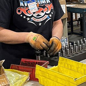 Spacesaver employee wearing gloves and picking out a drill bit