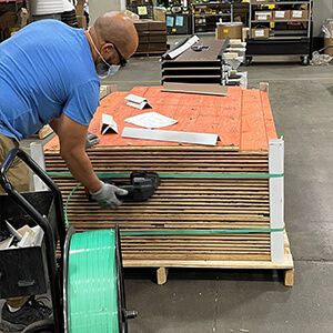 Spacesaver employee wearing a blue shirt getting pallet ready for shipment