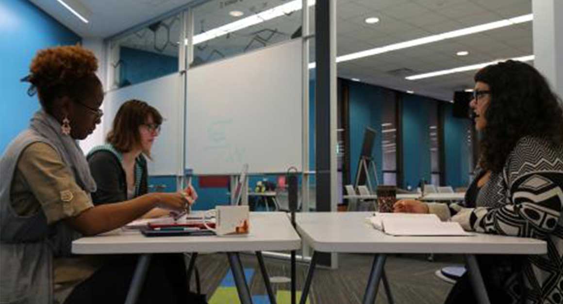 Professor teaching students in a learning commons space