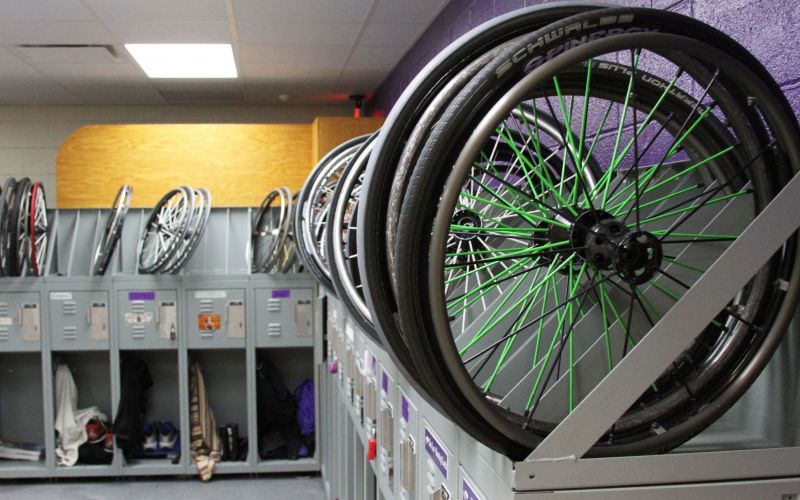Wheelchair wheels on top of custom lockers in wheelchair basketball team locker room