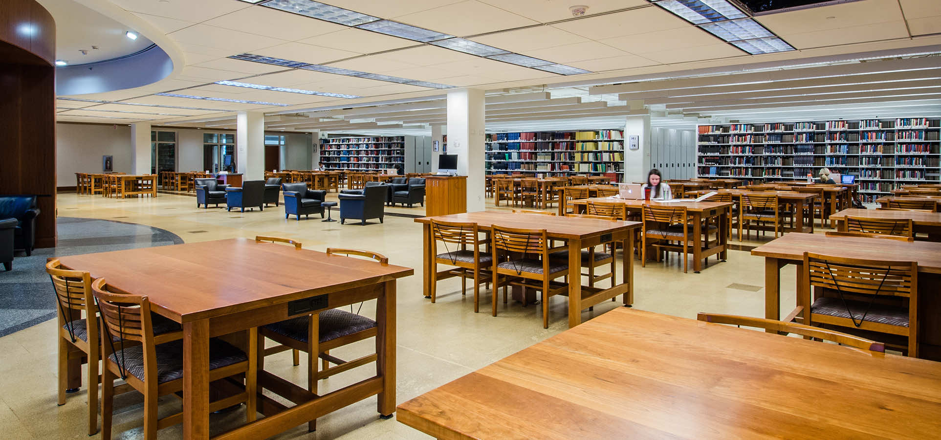 university library reading space with many tables and chairs