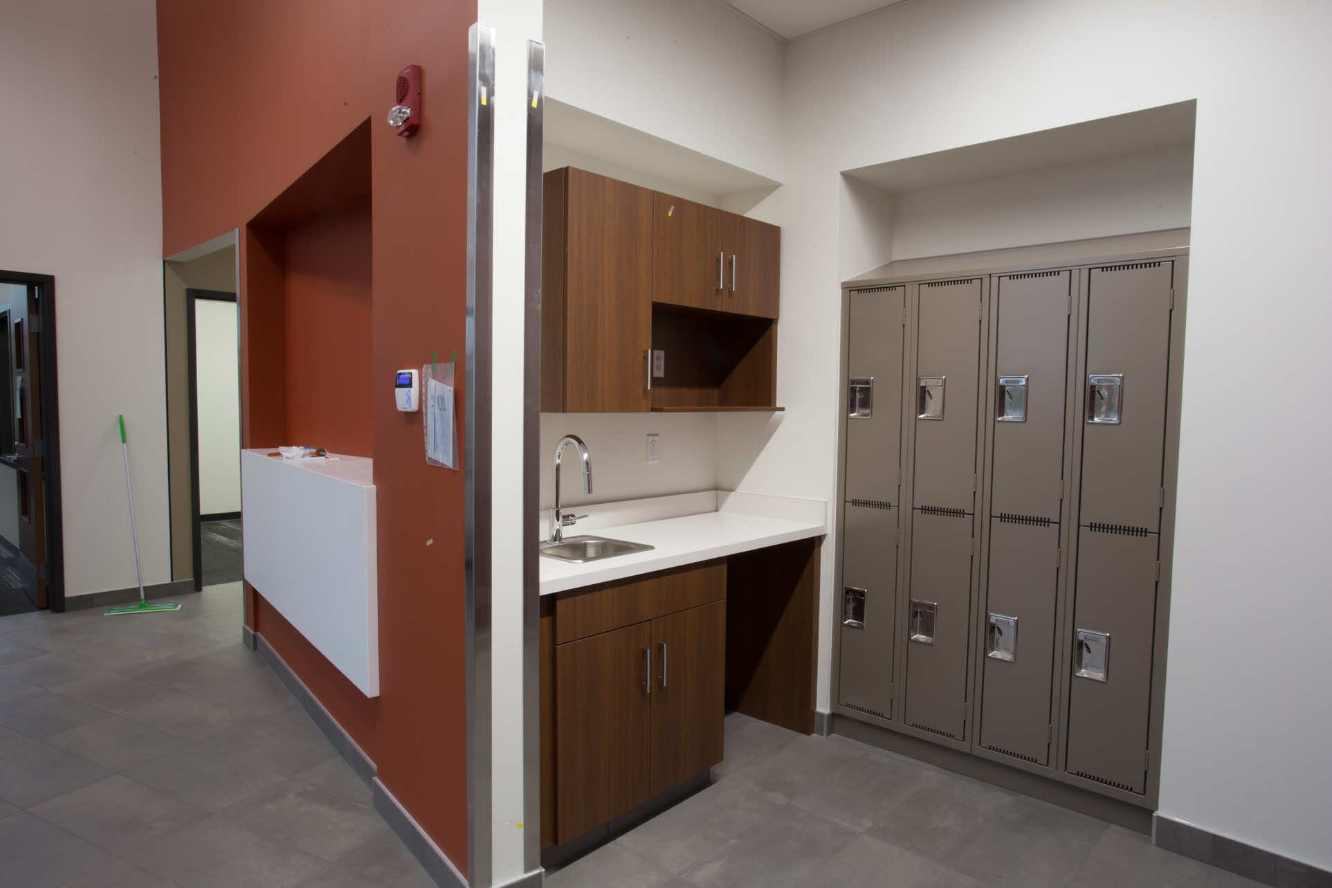 University of Alberta hallway with a sink and cabinets and Spacesaver personal storage lockers next to it